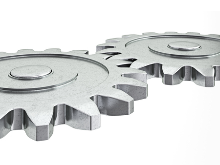 Teamwork success cooperation partnership concept: gear cogwheels working together isolated on whiteの写真素材