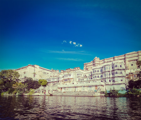 Vintage retro hipster style travel image of India luxury tourism concept background - Udaipur City Palace from Lake Pichola. Udaipur, Rajasthan, Indiaのeditorial素材