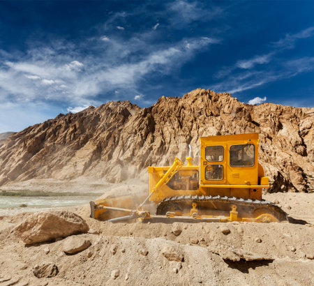 Bulldozer doing road construction in Himalayas. Ladakh, Jammu and Kashmir, India
