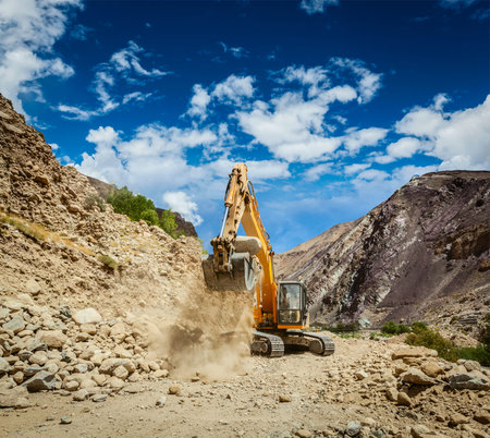Excavator doing road construction in Himalayas. Ladakh, Jammu and Kashmir, Indiaの写真素材