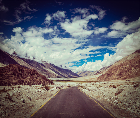 Vintage retro effect filtered hipster style travel image of Road in Himalayan landscape in Nubra valley in Himalayas. Ladakh, Indiaの写真素材
