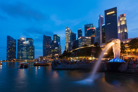 SINGAPORE - JANUARY 1, 2014: Night view of Singapore Merlion at Marina Bay against Singapore skyline. Merlion is a well-known tourist icon, mascot and national personification of Singaporeのeditorial素材