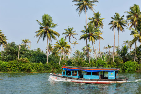 KERALA, INDIA - MAY 5, 2010: Unidentified indian people in small boat in backwaters. Kerala backwaters are both major tourist attraction and integral part of local people life in Keralaのeditorial素材