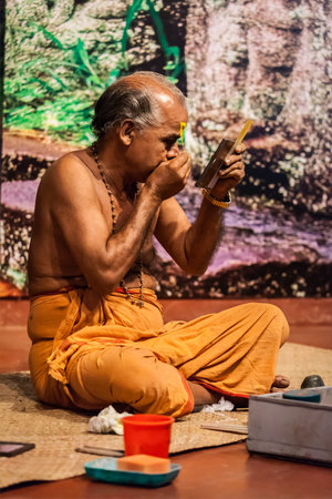 KOCHI, INDIA - FEBRUARY 24, 2013: Unidentified Kathakali exponent preparing for performance by...