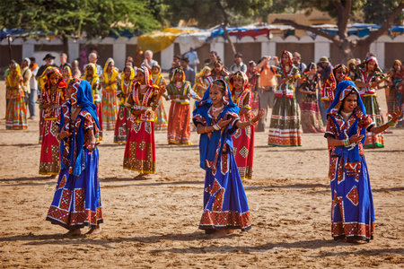 PUSHKAR, INDIA - NOVEMBER 21, 2012: Unidentified Rajasthani girls in traditional outfits dancing at...