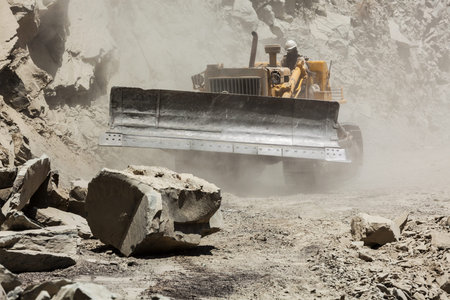 Bulldozer cleaning landslide on road in Himalayas