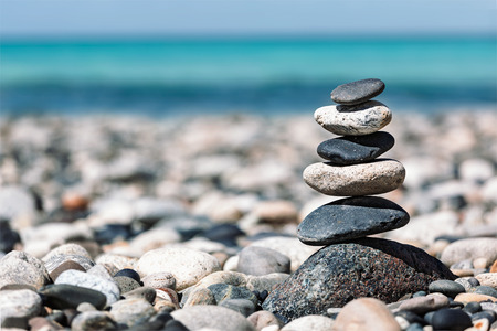 Zen meditation background -  balanced stones stack close up on sea beach