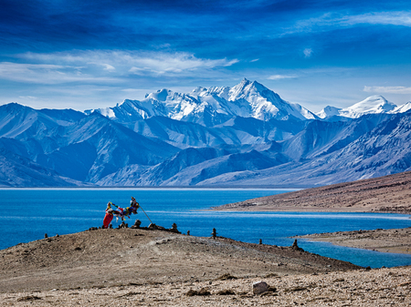 Buddhist prayer flags lungta at Himalayan lake Tso Moriri in the morning. Korzok, Ladakh, Jammu and Kashmir, Indiaの写真素材
