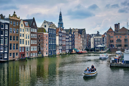 Canal cruise tourist boat in Amsterdam at Damrak canal and pierのeditorial素材