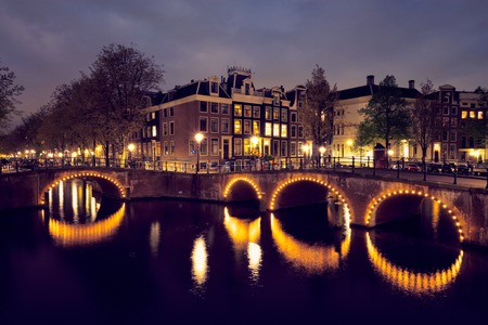 Amterdam canal, bridge and medieval houses in the eveningの写真素材