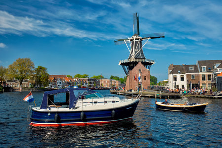 Harlem landmark  windmill De Adriaan and boat on Spaarne river.のeditorial素材