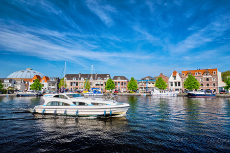Boats and houses on Spaarne river. Haarlem, Netherlandsのeditorial素材