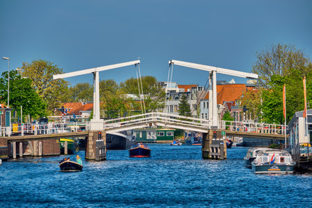 Boat passing under Gravestenenbrug bridge in Haarlem, Netherlandのeditorial素材