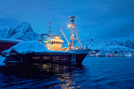 Fishing boat in Reine village at night. Lofoten islands, Norwayの写真素材