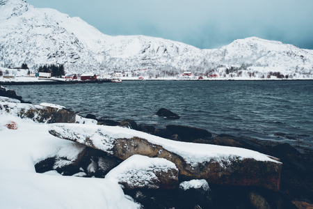 Norwegian fjord with red rorbu houses in Norway in winterの写真素材