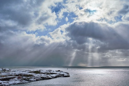 Norwegian sea in winter with sun raysの写真素材