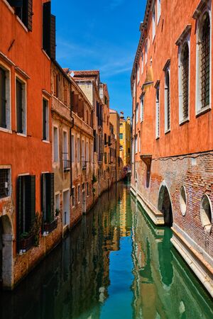 Narrow canal with houses in Venice, Italyの写真素材