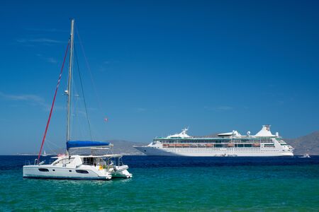 Catamaran yacht and cruise liner is Aegean sea. Chora, Mykonos island, Greeceの写真素材