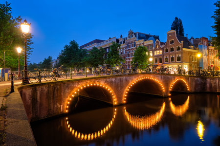 Amterdam canal, bridge and medieval houses in the eveningの写真素材