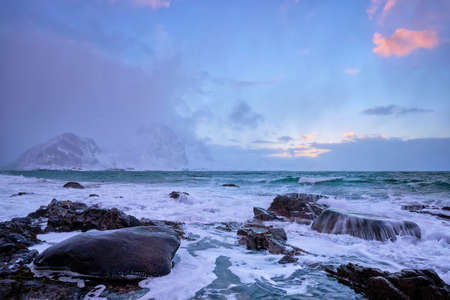 Coast of Norwegian sea on rocky coast in fjord on sunsetの写真素材