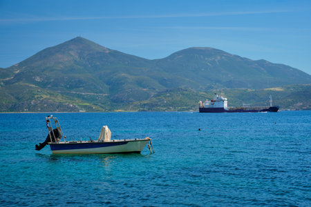 Greek fishing speed boat and cargo ship in the Aegean sea, Greeceの写真素材