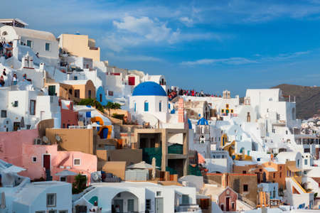Tourist crowd in a viewpoint in Oia Village, Santorini island, Greeceの写真素材