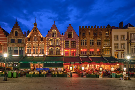 Bruges Grote markt square famous tourist place with many cafe and restaurants in the eveningのeditorial素材
