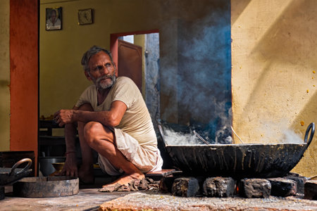 Pushkar, India - November 6, 2019: Street food stall cook cooking sweet puri bread and rabri sweet, condensed-milk-based dish in street of Pushkar, Rajasthan, Indiaのeditorial素材