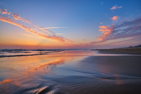 Atlantic ocean after sunset with surging waves at Fonte da Telha beach, Costa da Caparica, Portugal