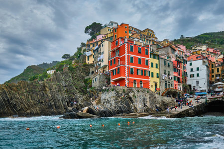 RIOMAGGIORE, ITALY - APRIL 25, 2019: Riomaggiore village popular tourist destination in Cinque Terre National Park a UNESCO World Heritage Site, Liguria, Italy in stormy weatherのeditorial素材