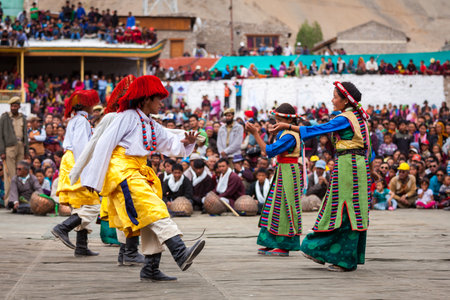 LEH, INDIA - SEPTEMBER 08, 2012: Young dancers in traditional Ladakhi Tibetan costumes perform folk dance at the Annual Festival of Ladakh Heritage in Leh, India. September 08, 2012のeditorial素材