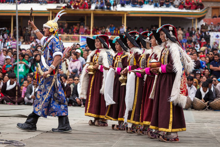 LEH, INDIA - SEPTEMBER 08, 2012: Dancers in traditional Ladakhi Tibetan costumes perform warlike dance at the Annual Festival of Ladakh Heritage in Leh, India. September 08, 2012のeditorial素材