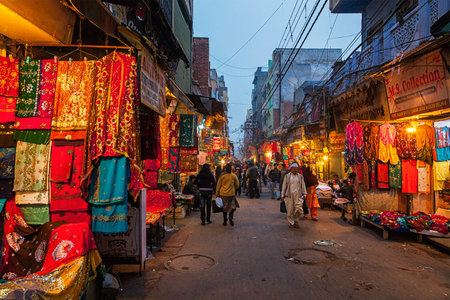 DELHI, INDIA - JANUARY 2, 2010: People in Chitli Qabar Bazar market street of Old Delhi in the eveningのeditorial素材