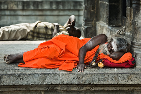 TIRUVANAMALLAI, INDIA - JANUARY 7, 2010: Sadhu - religious ascetic or holy person - sleeping in Hindu temple Arunachaleswar. Tiruvanamallai, Tamil Nadu, Indiaのeditorial素材