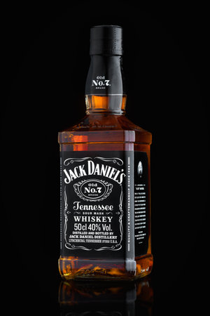 MINSK, BELARUS - OCTOBER 3, 2016: Bottle of Jack Daniel's Tennessee sour mash old no. 7 whiskey isolated on black with reflection - brand of Tennessee whiskey and top selling American whiskey in worldのeditorial素材