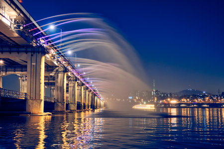SEOUL, SOUTH KOREA - APRIL 7, 2017: Banpo Bridge Rainbow Fountain tourist landmark on Han river illuminated at night, Seoul, South Koreaのeditorial素材