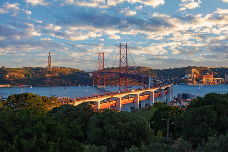 View of Lisbon view from Miradouro do Bairro do Alvito tourist viewpoint of Tagus river, traffic on...