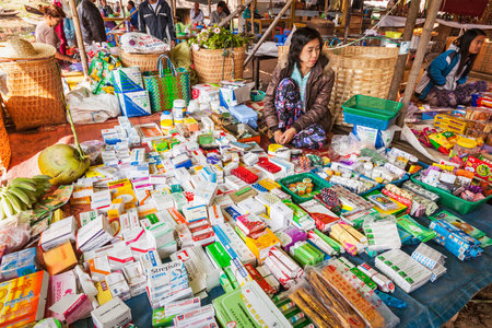 INLE LAKE, MYANMAR - JANUARY 7, 2014: Woman selling medicines and drugs at rural marketのeditorial素材