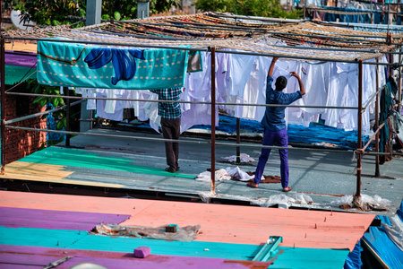 MUMBAI, INDIA - OCTOBER 31, 2019: Dhobi Ghat Mahalaxmi Dhobi Ghat is open air laundromat lavoir in Mumbai, India with laundry drying on ropes. Now signature landmark tourist attractions of Mumbaiのeditorial素材