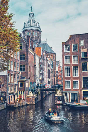 AMSTERDAM, NETHERLANDS - MAY 8, 2017: Canal cruise tourist boat in Amsterdam canal. Amsterdam, capital of the Netherlands, has more than one hundred kilometers of canalsのeditorial素材