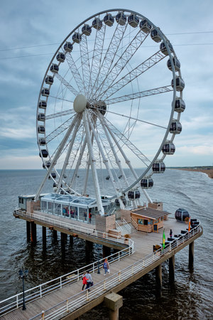 The Hague, Netherlands - May 13, 2017: The Scheveningen Pier Strandweg, beach resort on North sea in The Hague Den Haag with Ferris wheel. The Hague, Netherlandsのeditorial素材