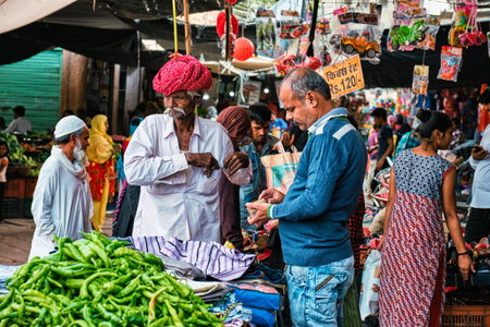 Jodhpur, India - November 14, 2019: Man in traditional Rajasthani attire and Local peopel in vegetable and fruit market in Sadar Market. Jodhpur, Rajasthan, Indiaのeditorial素材