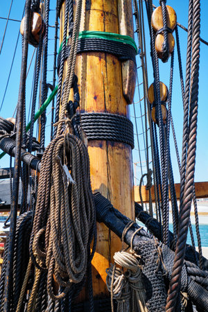 Mast of old wooden Age of sail sailing ship with ropes cordage and shroudの写真素材