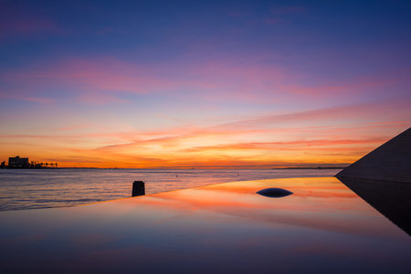 Fountain and pool near the Champalimaud foundation - Portuguese non-profit foundation for scientific medical research in Belem with sunset reflectionの写真素材