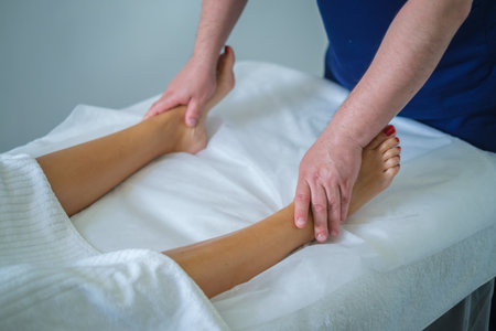 A woman enjoys a soothing calf massage at a spa salon, enhancing her wellness with a skilled therapist's touch.の写真素材