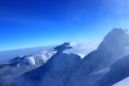 Mountain peak is covered with white snow in Tatrasの写真素材