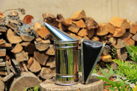 Closeup of bee smoker on crate at farmの写真素材