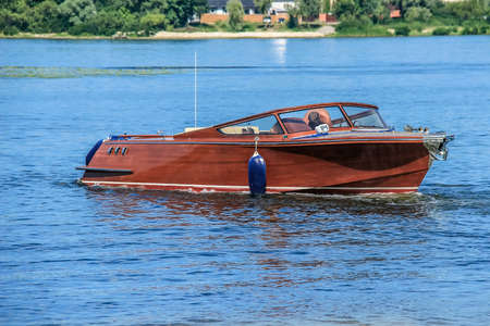 retro wooden boat floating on the waterの写真素材