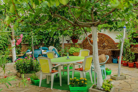Lounge area for guests outside  White sofas and chairs around the table with flowers outsideの写真素材