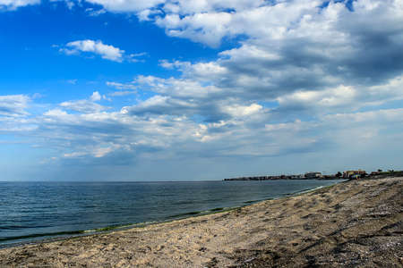 Beach summer clear day on a background of red cloudsの写真素材